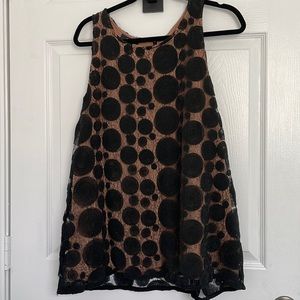 Black embellished design over natural underlay.